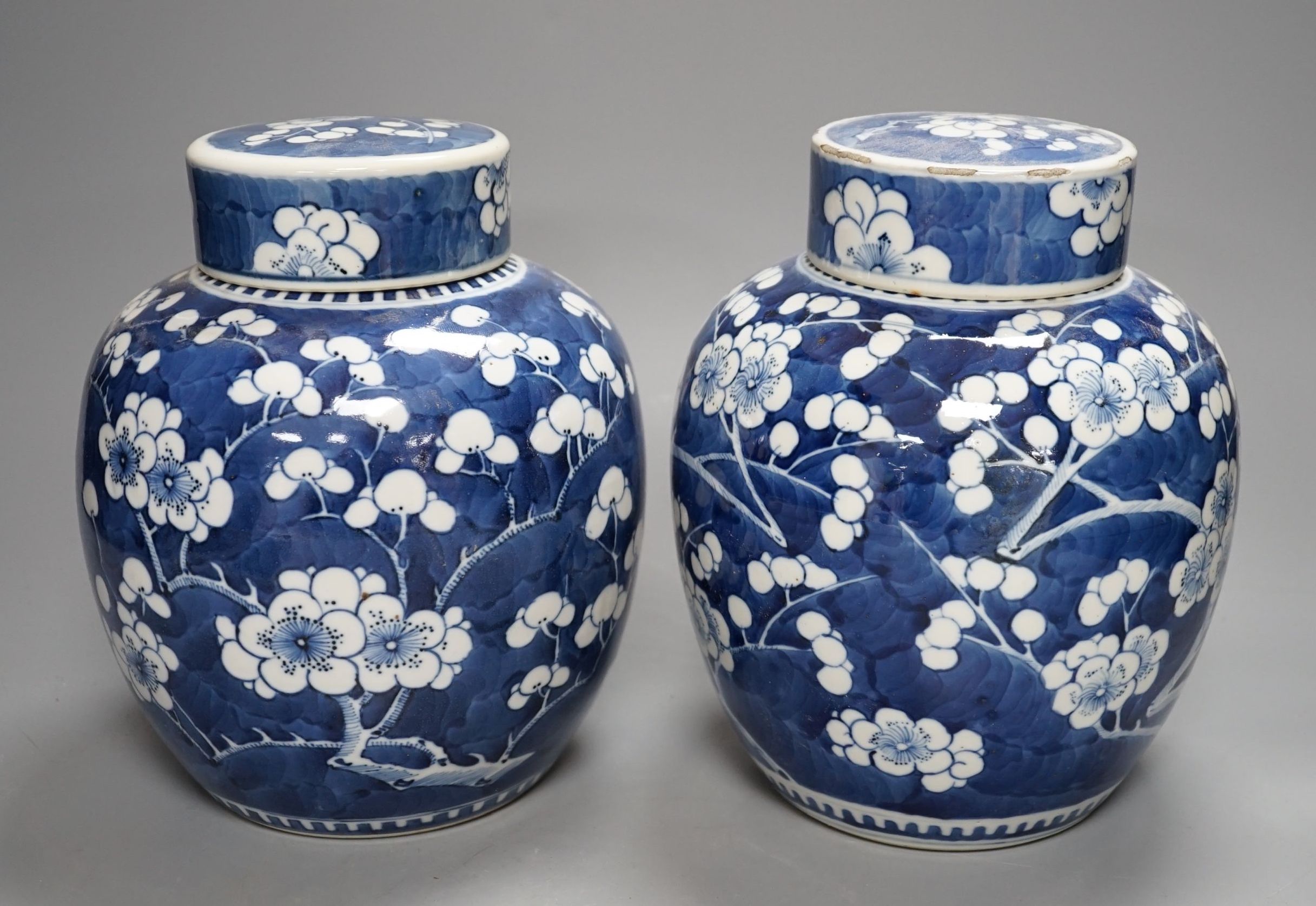 A pair of Chinese blue and white ginger jars and covers, 22 cms high including cover.